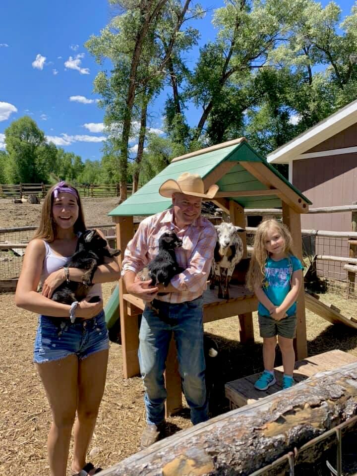 Adam with some baby goats at the ranch